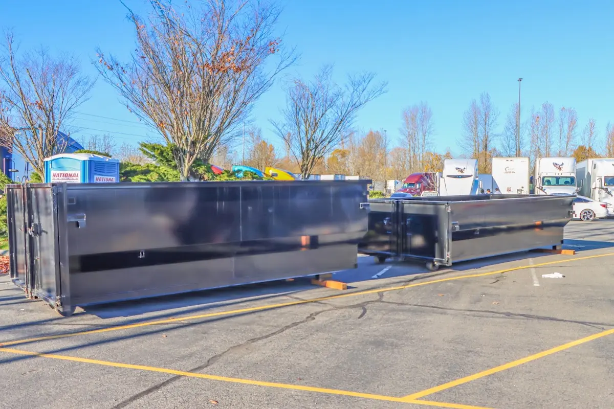 Professional dumpster rental service with roll-off container on residential driveway in View Park-Windsor Hills